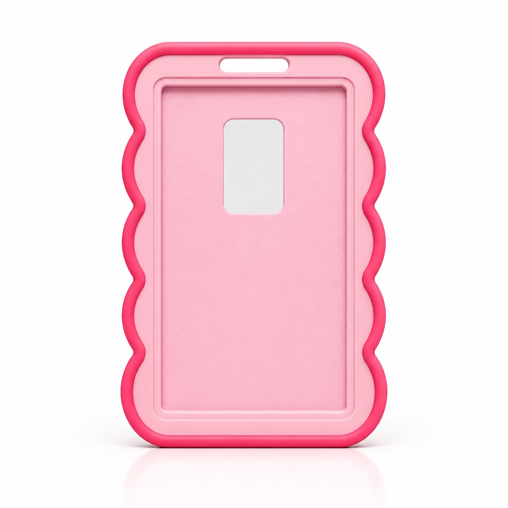 A pink id holder with a wavy scalloped border and a rectangular camera cutout, standing upright on a bright pink surface against a light gray background.