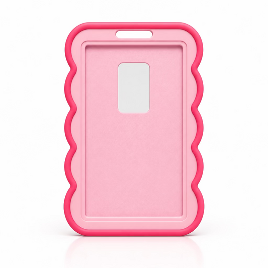 A pink id holder with a wavy scalloped border and a rectangular camera cutout, standing upright on a bright pink surface against a light gray background.