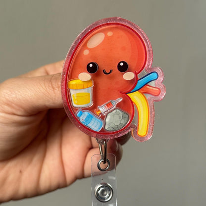 Hand holding a cartoon-style liver badge holder with medical icons on a plain background