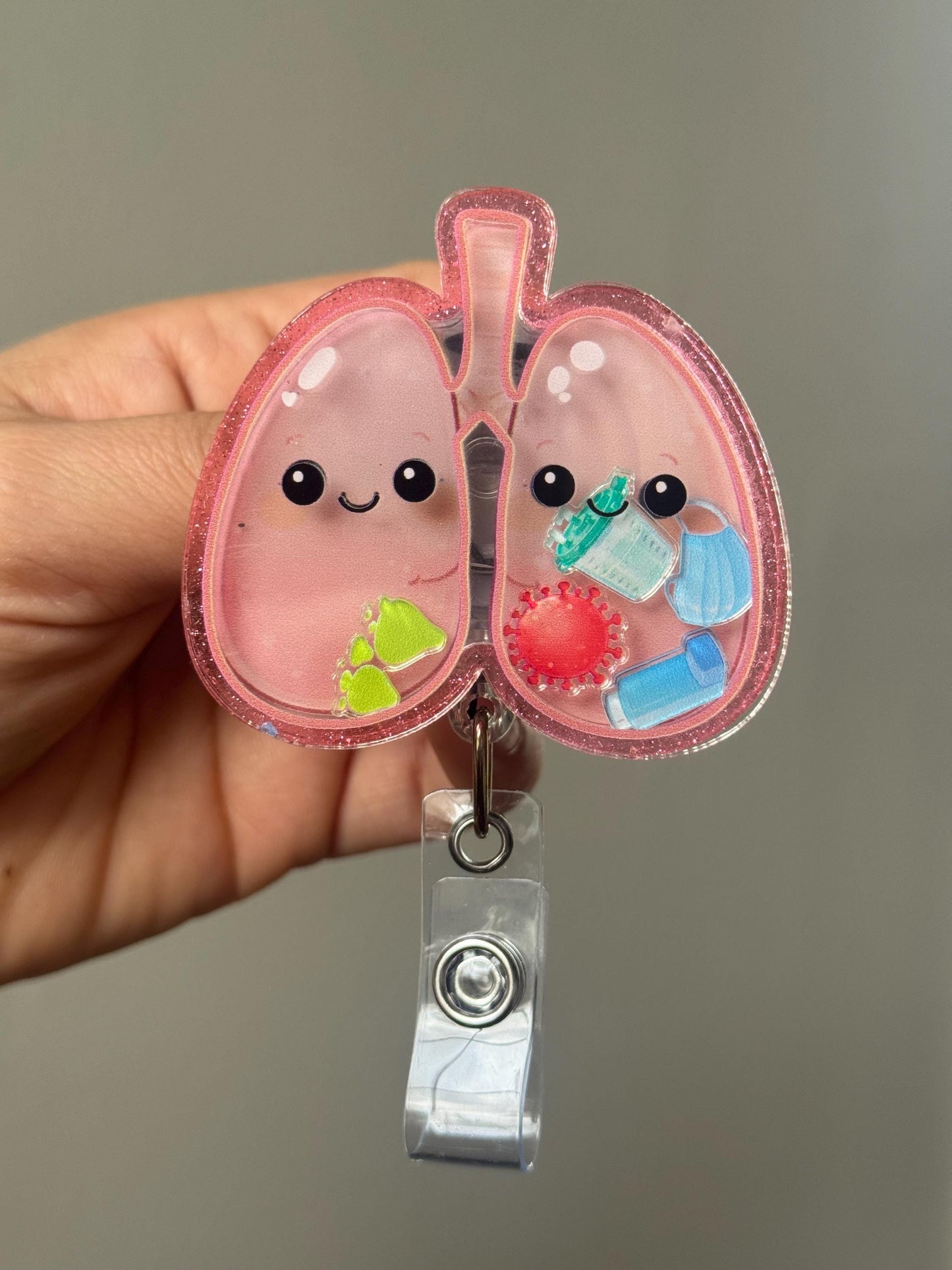 Cute cartoon lungs design on a badge holder against a neutral background