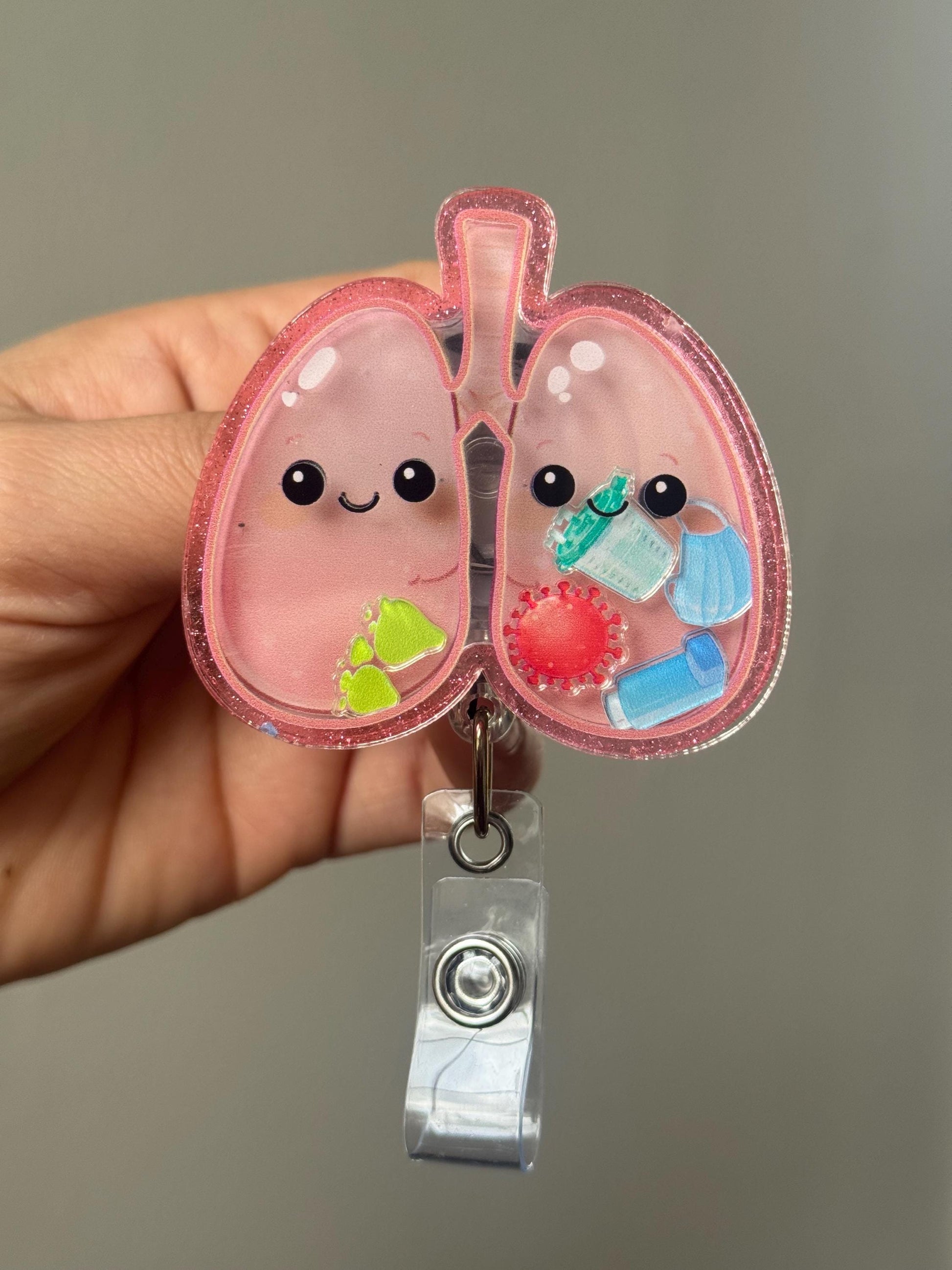 Cute cartoon lungs design on a badge holder against a neutral background