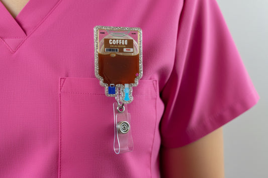 Decorative badge holder with coffee design held by a hand against a plain background